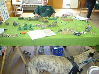 Warhammer game apparently between the club president and a visiting greyhound.